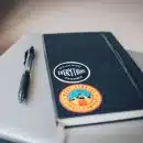 black book cover near black click pen