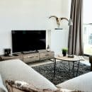 black flat screen tv on brown wooden tv rack
