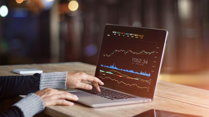 Businessman using laptop for analyzing data stock market, forex trading graph, stock exchange trading online, financial investment concept. All on laptop screen are design up.