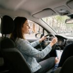 Jeune femme apprenant à conduire dans les rues de Lyon avec un moniteur d'auto-école