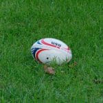 white and blue soccer ball on green grass field during daytime