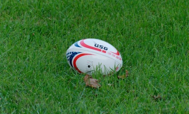 white and blue soccer ball on green grass field during daytime